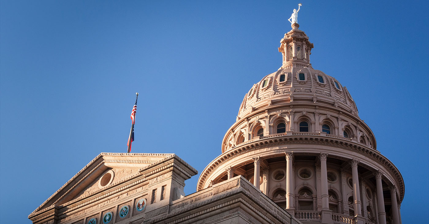 Texas state capitol building dome with a blue sky in the background