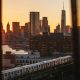 Manhattan and train view from behind a window curtain as the sun sets