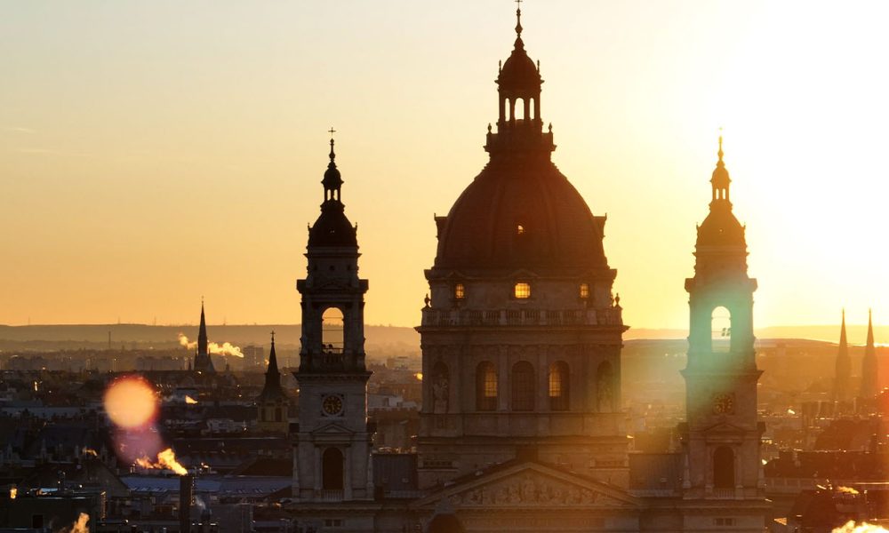 Aerial view of the famous St. Stephen's Basilica in Budapest at sunrise St. Stephen's Basilica is a Roman Catholic basilica in Budapest, Hungary. It is named in honour of Stephen, the first King of Hungary, whose right hand is housed in the reliquary. Since the renaming of the primatial see, it has been the co-cathedral of the Roman Catholic Archdiocese of Esztergom-Budapest. Today, it is the third largest church building in present-day Hungary. It is the largest church in Budapest and a World Heritage Site. (Photo by Guven Ozdemir)