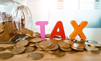 Glass jar saving coins for tax.