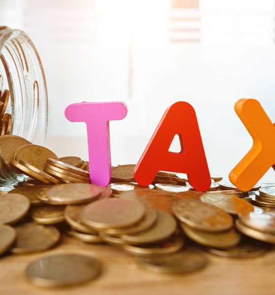 Glass jar saving coins for tax.