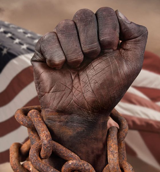 Dark hand in chains with American flag behind
