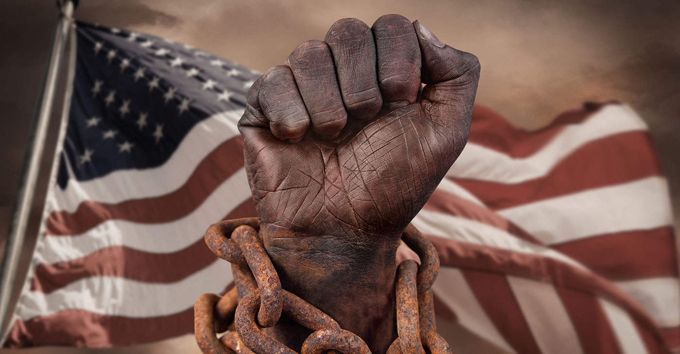 Dark hand in chains with American flag behind
