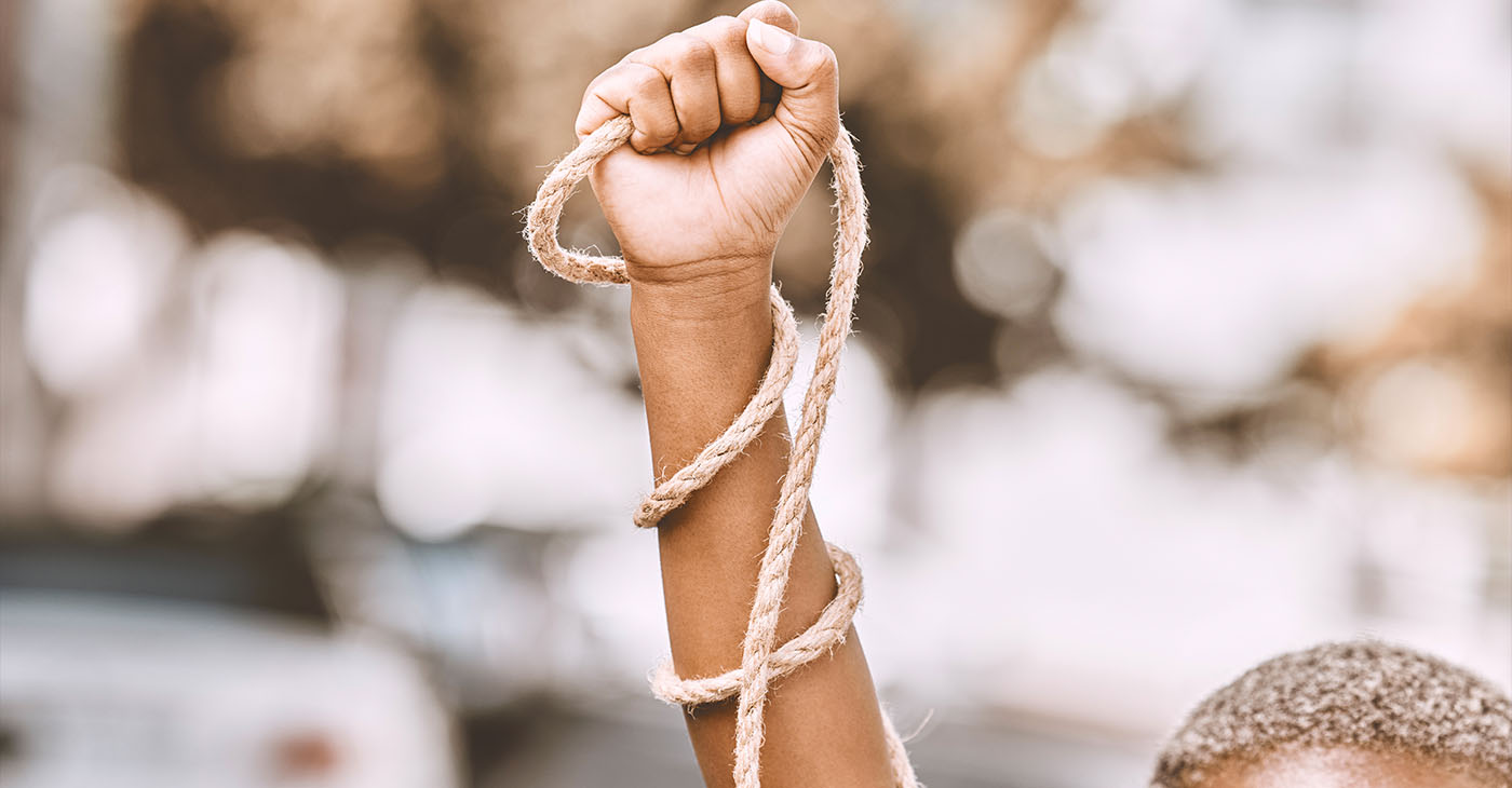 Hand, rope and fist protest slavery for freedom and human rights against an urban background. Activist, activism and rebellion against racism and change for civil, law and government rights (Photo by Jacob Wackerhausen)