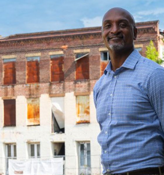 Phillip Howard of the Conversation standing in front of the Edistone Hotel in Selma Alabama. (Attribution, The Conservation Fund.)