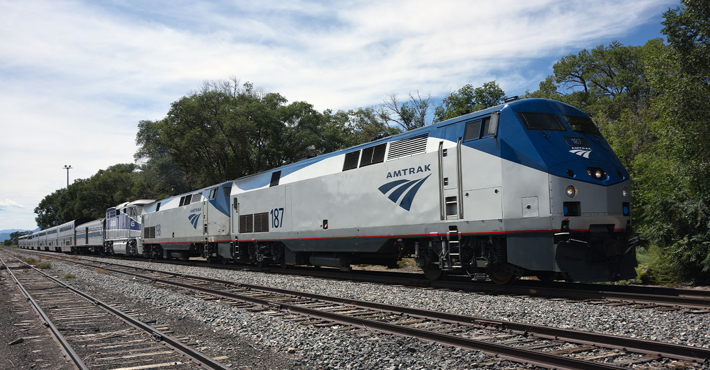 Lamy, United States - September 8, 2015:The eastbound Amtrak Southwest Chief passenger train at Lamy, New Mexico, USA. The train has travelled overnight from Los Angeles and is heading for Chicago. The train is powered by a pair of GE P42DC, numbers 187 and 198, and a single EMD F59PHI locomotive, number 455, all diesels. This train, and its westbound counterpart, are the only two trains to traverse this route per day as it has no freight service. Unidentified crew.