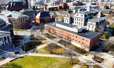 Aerially passing over an educational institutions college campus that is primarily vacant because of spring break which gives a comfortable feeling similar to a quaint but prestigious village (Photo by Thomas Berberich)