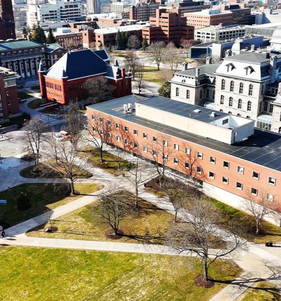 Aerially passing over an educational institutions college campus that is primarily vacant because of spring break which gives a comfortable feeling similar to a quaint but prestigious village (Photo by Thomas Berberich)