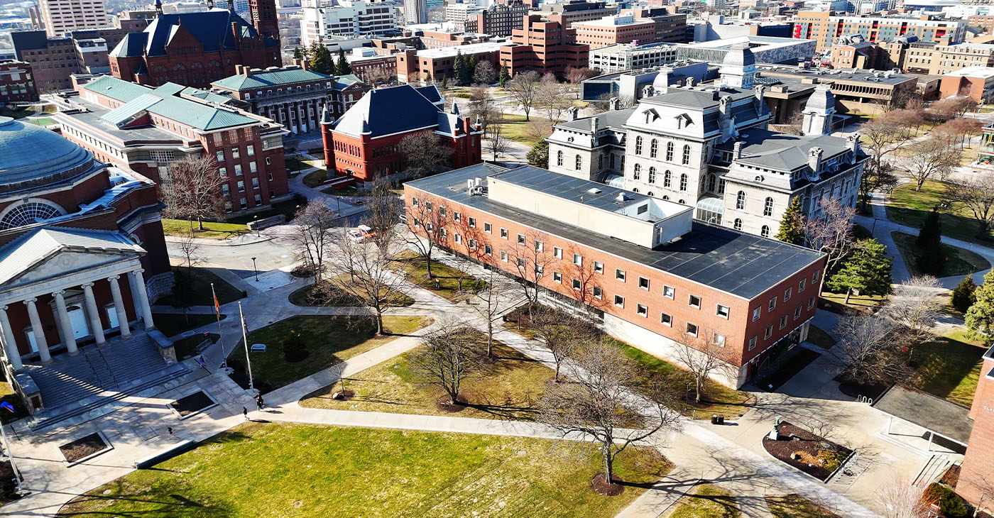 Aerially passing over an educational institutions college campus that is primarily vacant because of spring break which gives a comfortable feeling similar to a quaint but prestigious village (Photo by Thomas Berberich)