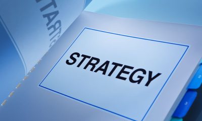 A still life of a working business plan book. A fundamental document that guide a business venture, its strategy, positioning, market, administration, management and all aspect of any business.