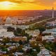 Helicopter shot of Capitol Hill in Washington, D.C. at sunset on a fall evening, looking over residential streets towards the U.S. Capitol Building, Supreme Court, and the National Mall.