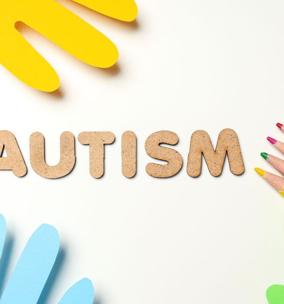 Multicolored paper hands with pencils on white background. World autism day concept (Photo by Liliia Bila)
