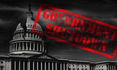 The United States capitol building with a crack and red Government Shutdown stamp