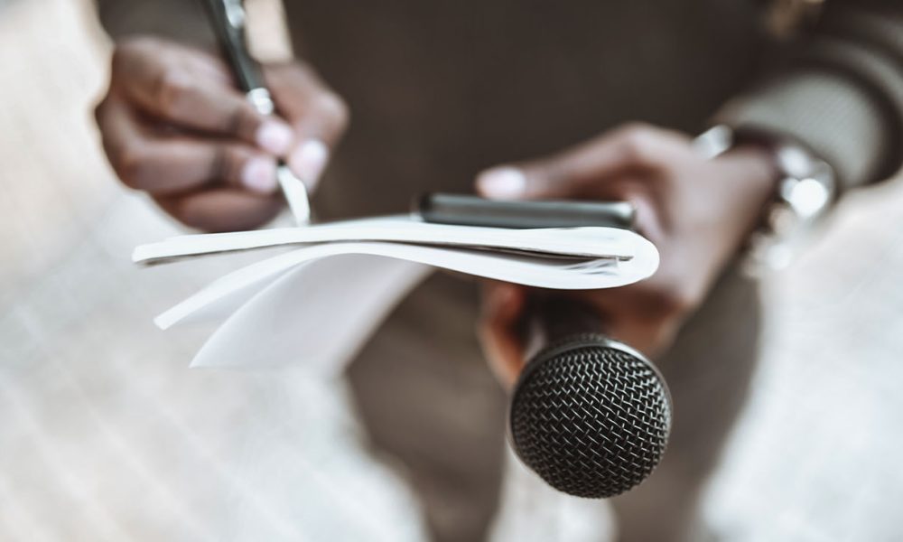 Male Journalist Preparing Questions For Press Conference (Photo by Aleksandar Georgie)