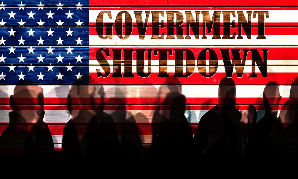 Lot of people shadows against USA flagged fence, shutdown concept