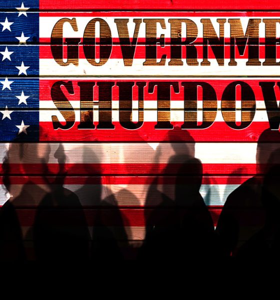 Lot of people shadows against USA flagged fence, shutdown concept