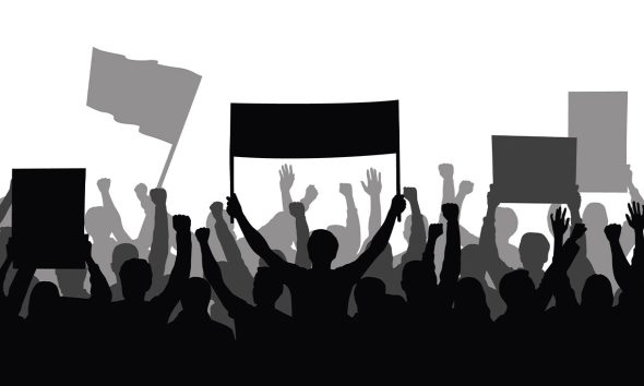 Silhouette of a crowd of people with hands in the air - show spectators, sport fans, protest, demonstration, music festival, people cheering vector illustration