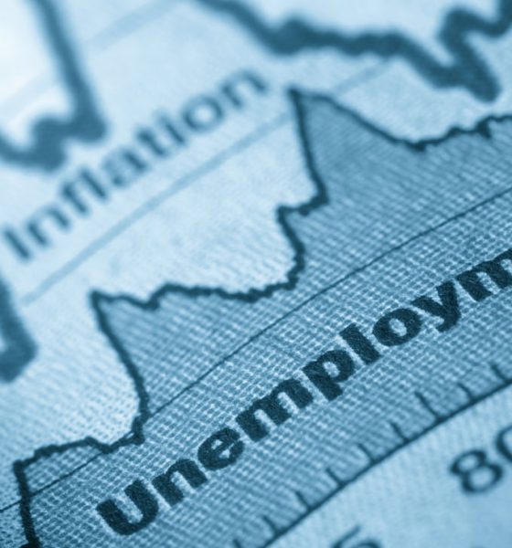Business graph unemployment and inflation in newspapers
