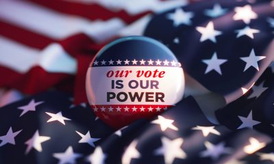 Our Vote Is Our Power printed badge over American flag. Horizontal composition. Election concept.