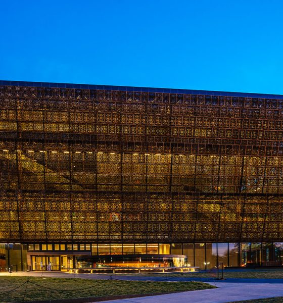 Washington D.C., USA - February 10, 2023: The National Museum of African American History and Culture at night with the Washington Monument in downtown Washington DC.