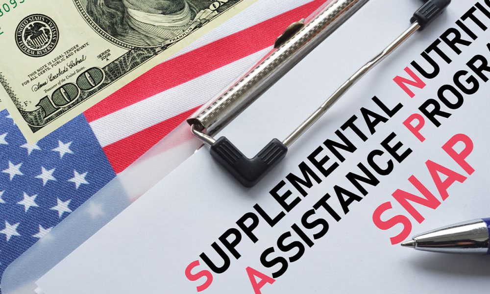 SNAP Supplemental Nutrition Assistance Program is shown using the text. SNAP provides food benefits to low-income families in US (Photo by Andrii Dodonov)
