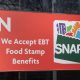Chicago - Circa April 2022: SNAP and EBT Accepted here sign. SNAP and Food Stamps provide nutrition benefits to supplement the budgets of disadvantaged families.