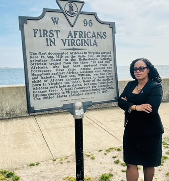 Thena Robinson Mock pictured next to the site recognizing the arrival of the first documented Africans in Virginia. Photo courtesy Thena Robinson Mock.