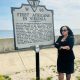 Thena Robinson Mock pictured next to the site recognizing the arrival of the first documented Africans in Virginia. Photo courtesy Thena Robinson Mock.