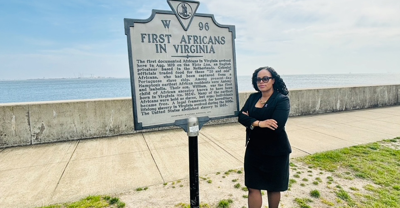 Thena Robinson Mock pictured next to the site recognizing the arrival of the first documented Africans in Virginia. Photo courtesy Thena Robinson Mock.