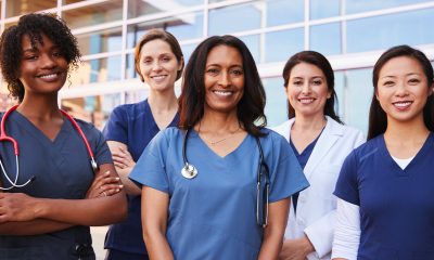Female healthcare colleagues standing outside hospital