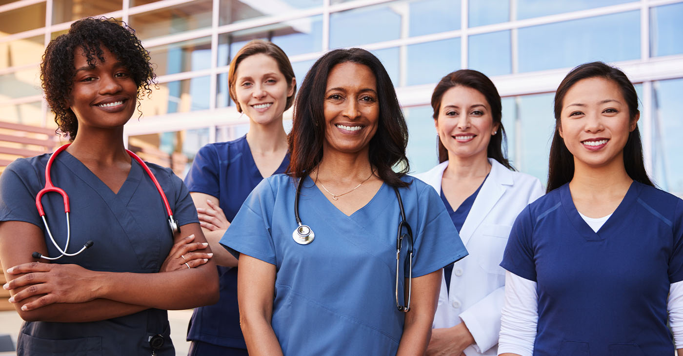 Female healthcare colleagues standing outside hospital