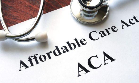 Words Affordable Care Act ACA written on a paper.