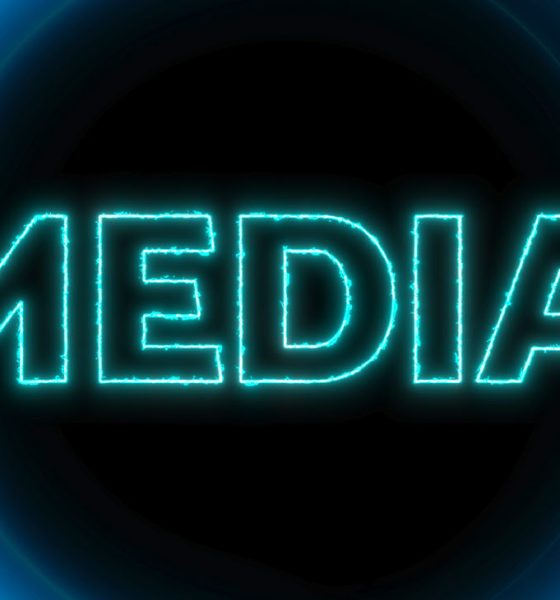 Neon blue circles with word media glowing on a dark background.