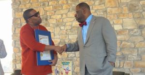 Thompson (left), with the Fulton County Proclamation, presented by Atlanta City Council member Marvin Arrington Jr.  Photo by Noah Washington/The Atlanta Voice