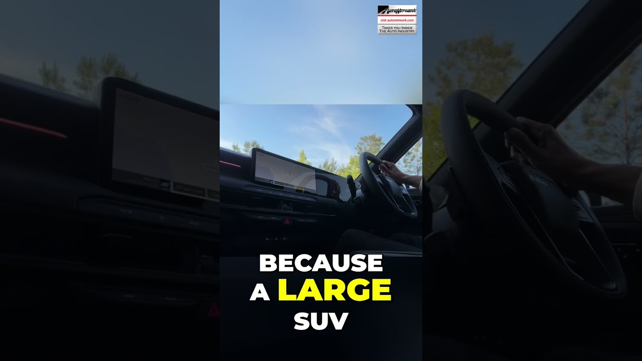 Interior of a car cabin with a large touchscreen/dashboard visible and bold text overlay: 'BECAUSE A LARGE SUV' in white and yellow.