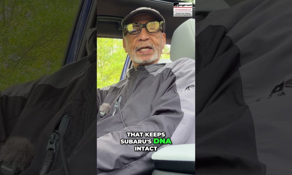Man wearing a cap and glasses sits in a car, speaking to the camera; bold caption reads, 'That keeps Subaru's DNA intact' with 'DNA' highlighted in green.