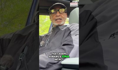 Man wearing a cap and glasses sits in a car, speaking to the camera; bold caption reads, 'That keeps Subaru's DNA intact' with 'DNA' highlighted in green.