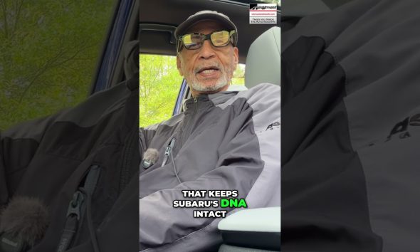 Man wearing a cap and glasses sits in a car, speaking to the camera; bold caption reads, 'That keeps Subaru's DNA intact' with 'DNA' highlighted in green.