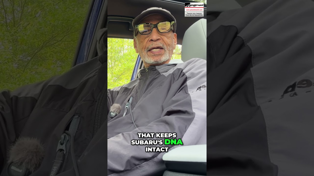 Man wearing a cap and glasses sits in a car, speaking to the camera; bold caption reads, 'That keeps Subaru's DNA intact' with 'DNA' highlighted in green.
