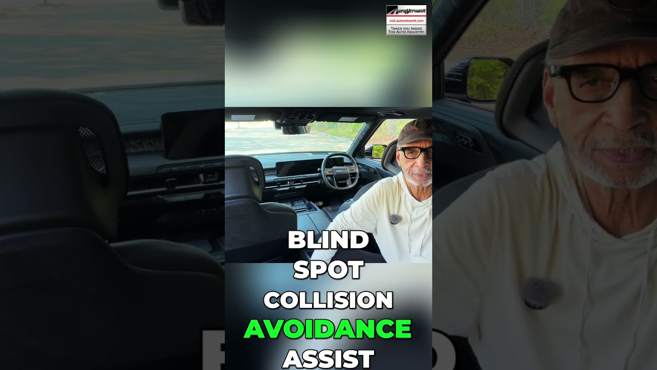 Man wearing a cap and glasses sits in a car interior with bold white text about blind-spot collision avoidance.