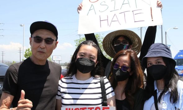 Patricia Roque (far right) pictured with her family at a Stop Asian Hate rally after her father's assault (far left). (Courtesy of AAPI Equity Alliance)
