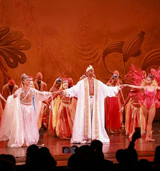 A performer from the Dance Theatre of Harlem is captured mid-dance, showcasing the elegance and athleticism of ballet. Photo courtesy New York Carib News.