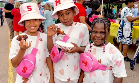Three young festivalgoers enjoy wings together, reflecting the family-friendly atmosphere at the annual event, where community and giving back are at the heart of the celebration. (Courtesy photo)
