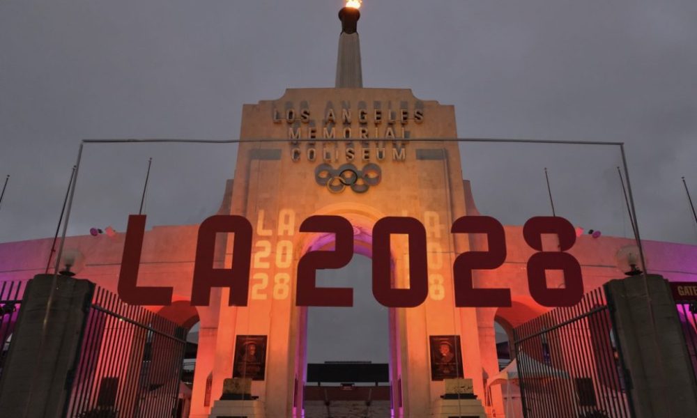 An LA2028 sign in front of a blazing Olympic cauldron at the Los Angeles Memorial Coliseum on Wednesday, Sept. 13, 2017. The cauldron was lit early Wednesday morning at the stadium that was the site of the 1932 and 1984 Olympics. (AP Photo/Richard Vogel)