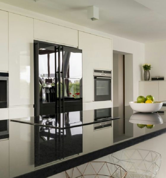 A modern kitchen featuring natural stone countertops and hardwood flooring.