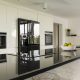 A modern kitchen featuring natural stone countertops and hardwood flooring.