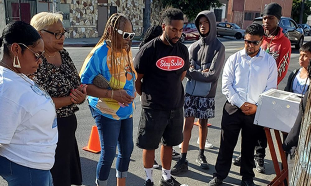 Relatives and friends of Michael Smith attend a ‘ghost bike’ ceremony for him Aug. 24 in South Los Angeles, Smith, 12, was hit by a car while riding his bike July 22. He was the 12th bicyclist to be killed in South Los Angeles this year.