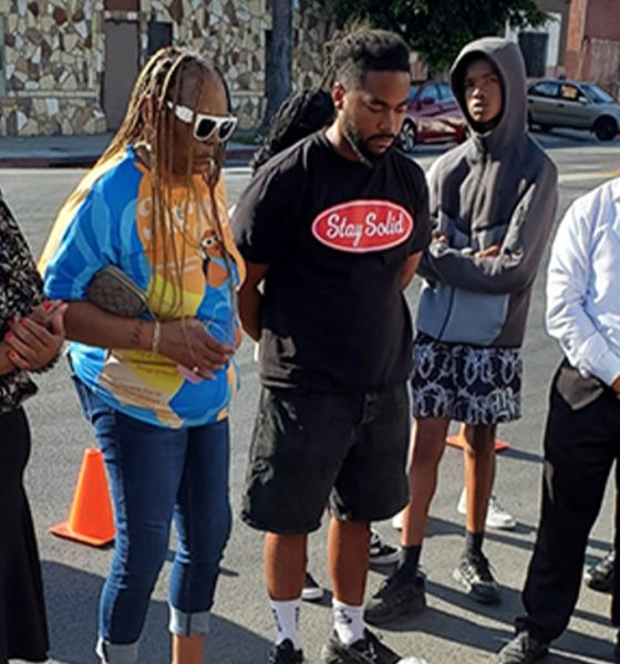 Relatives and friends of Michael Smith attend a ‘ghost bike’ ceremony for him Aug. 24 in South Los Angeles, Smith, 12, was hit by a car while riding his bike July 22. He was the 12th bicyclist to be killed in South Los Angeles this year.