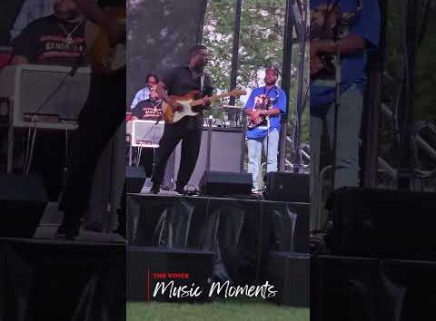 Jubu Smith performing guitar on stage at Juneteenth ICT, Kansas