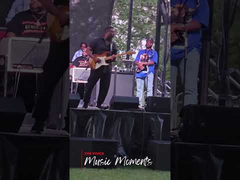 Jubu Smith performing guitar on stage at Juneteenth ICT, Kansas